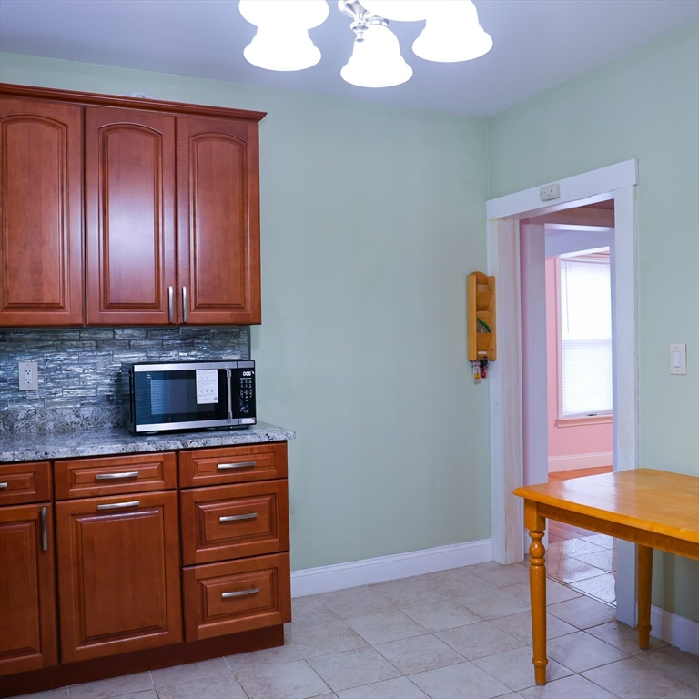 186 Powell Street Lowell, MA 01851 - Photo 18 of 42 a room with cabinets and chair