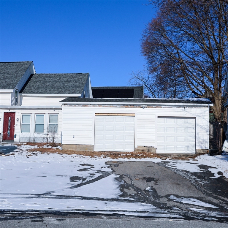 186 Powell Street Lowell, MA 01851 - Photo 2 of 42 a front view of a house with a yard