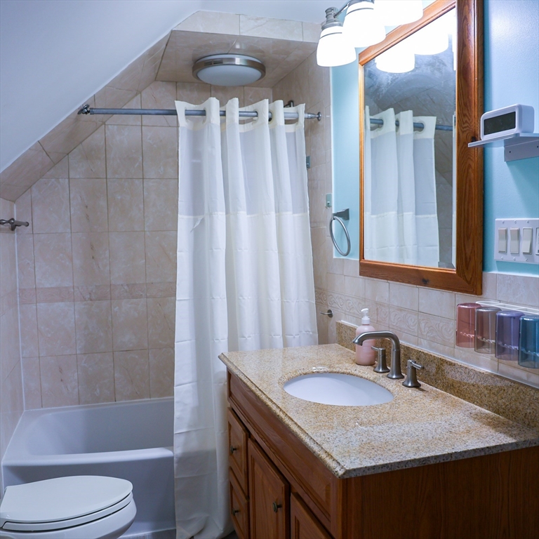 186 Powell Street Lowell, MA 01851 - Photo 39 of 42 a bathroom with a granite countertop sink toilet and shower