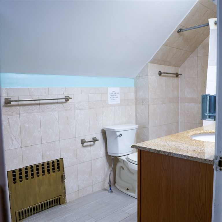 186 Powell Street Lowell, MA 01851 - Photo 41 of 42 a bathroom with a sink a toilet and shower