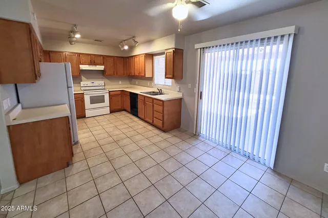 a kitchen with a sink a counter top space cabinets and stainless steel appliances