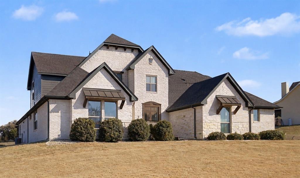 2104 Cash Point Court Granbury, TX 76049 - Photo 1 of 1 a front view of a house with a yard