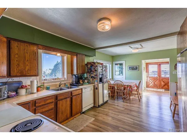 a kitchen with stainless steel appliances granite countertop sink stove and wooden cabinets