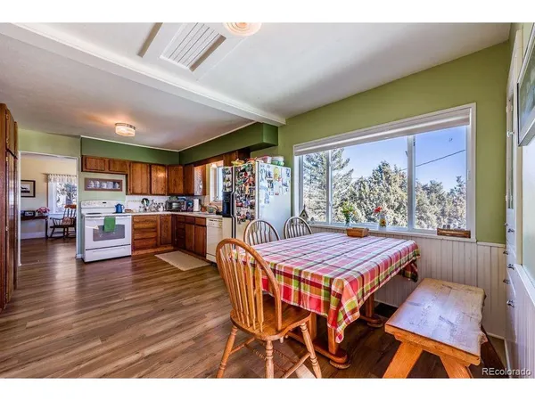 a dining room with furniture and wooden floor