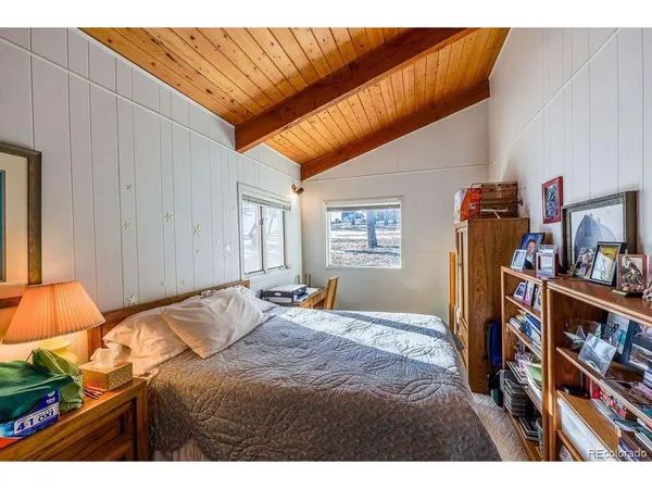 a bedroom with a bed and a book shelf