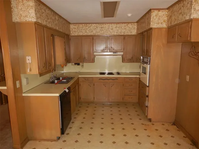 a kitchen with a sink a stove and refrigerator