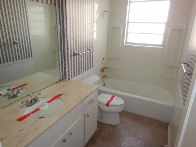 a bathroom with a tub sink and a window