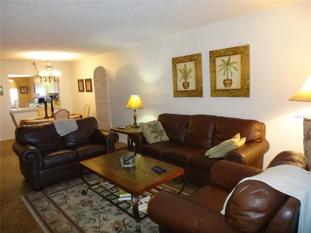 a living room with furniture and a lamp