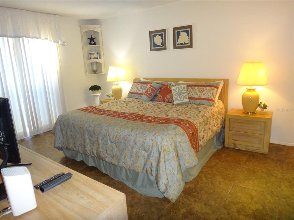 4493 Longmeadow, Unit 76 Sarasota, FL 34235 - Photo 15 of 24 a bedroom with a bed and a window