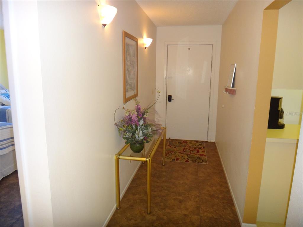 4493 Longmeadow, Unit 76 Sarasota, FL 34235 - Photo 4 of 24 a hallway with wooden door