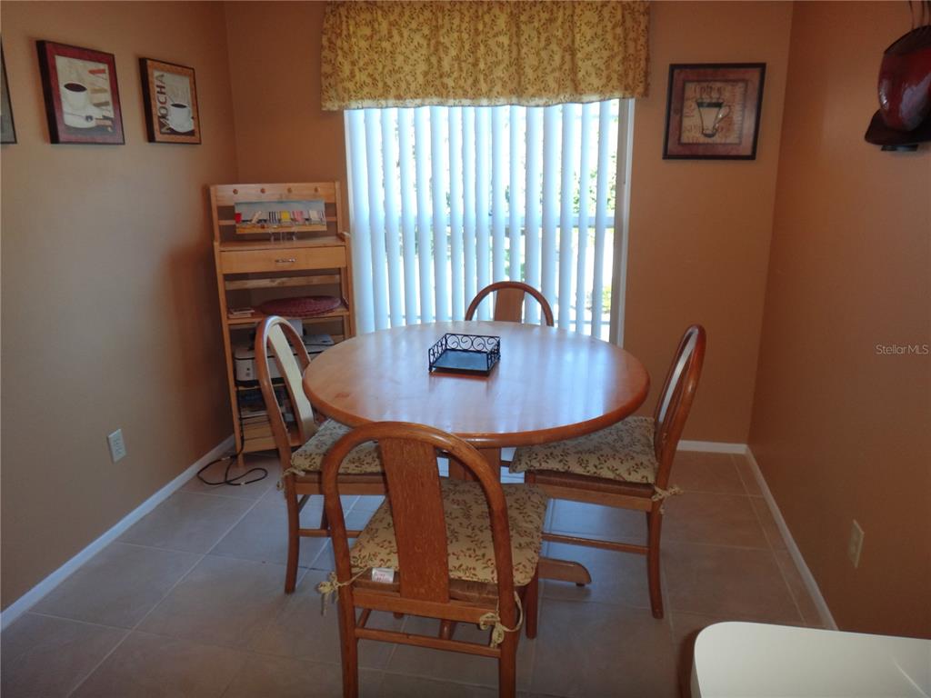 4493 Longmeadow, Unit 76 Sarasota, FL 34235 - Photo 5 of 24 a view of a dining room with furniture and window