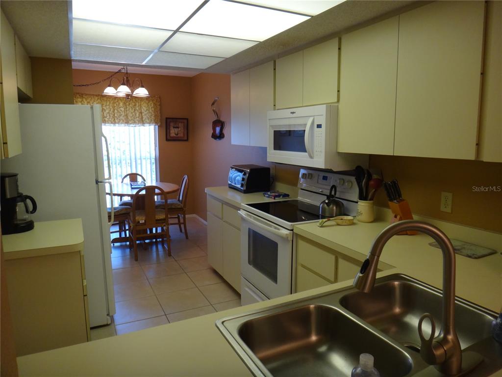 4493 Longmeadow, Unit 76 Sarasota, FL 34235 - Photo 6 of 24 a kitchen with a sink cabinets and appliances