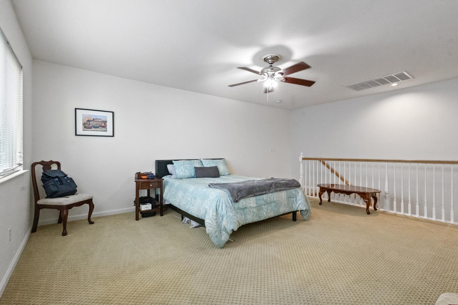1413 Villette Court Modesto, CA 95356 - Photo 14 of 82 a spacious bedroom with a bed and a chandelier