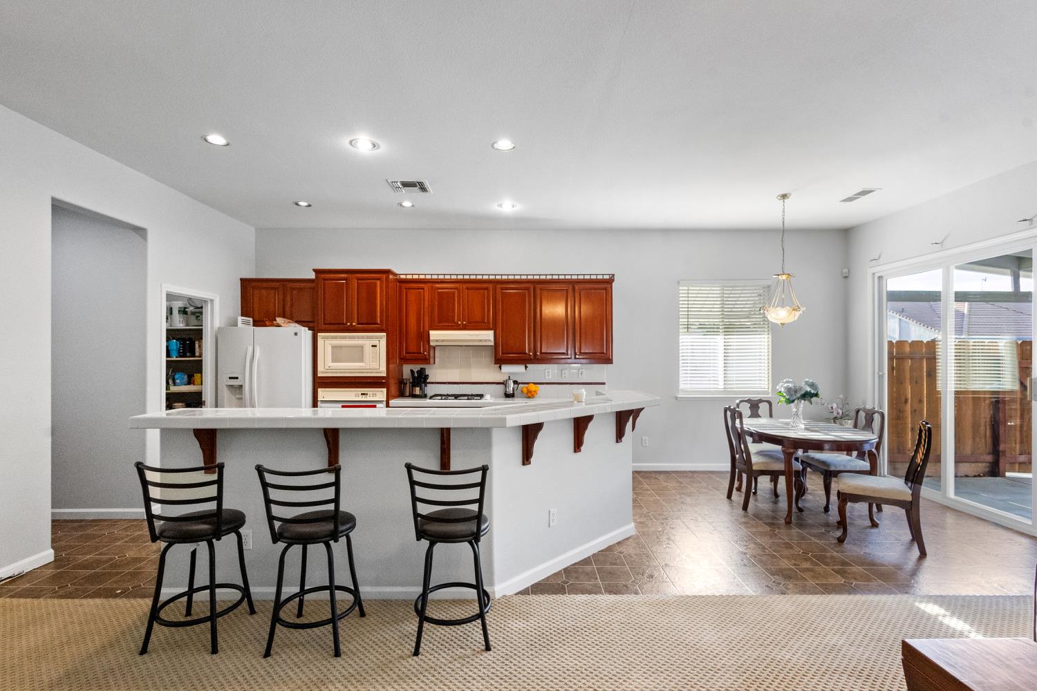 1413 Villette Court Modesto, CA 95356 - Photo 15 of 82 a kitchen with a table and chairs in it