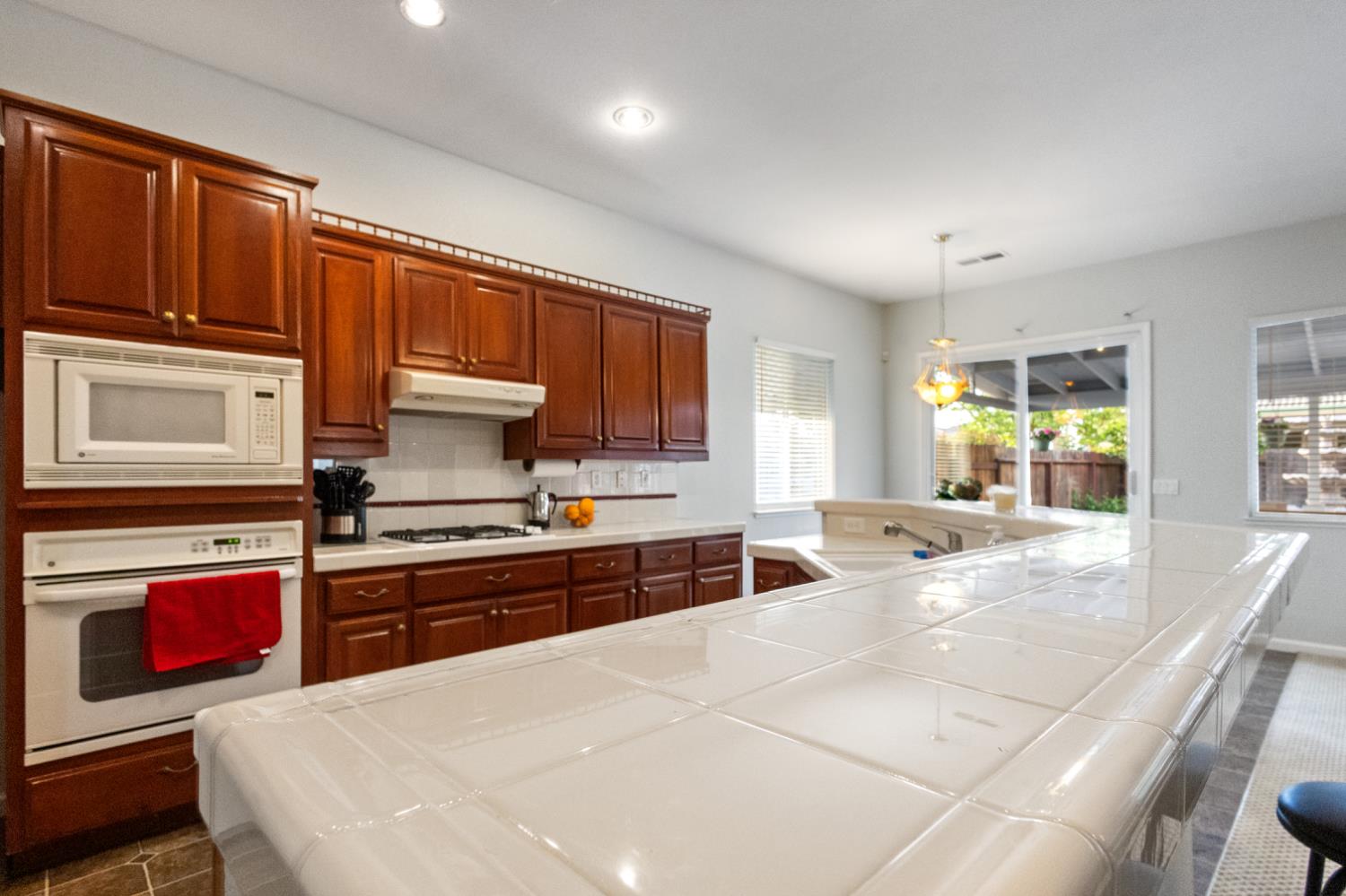1413 Villette Court Modesto, CA 95356 - Photo 32 of 82 a kitchen with stainless steel appliances granite countertop a stove a sink and a microwave