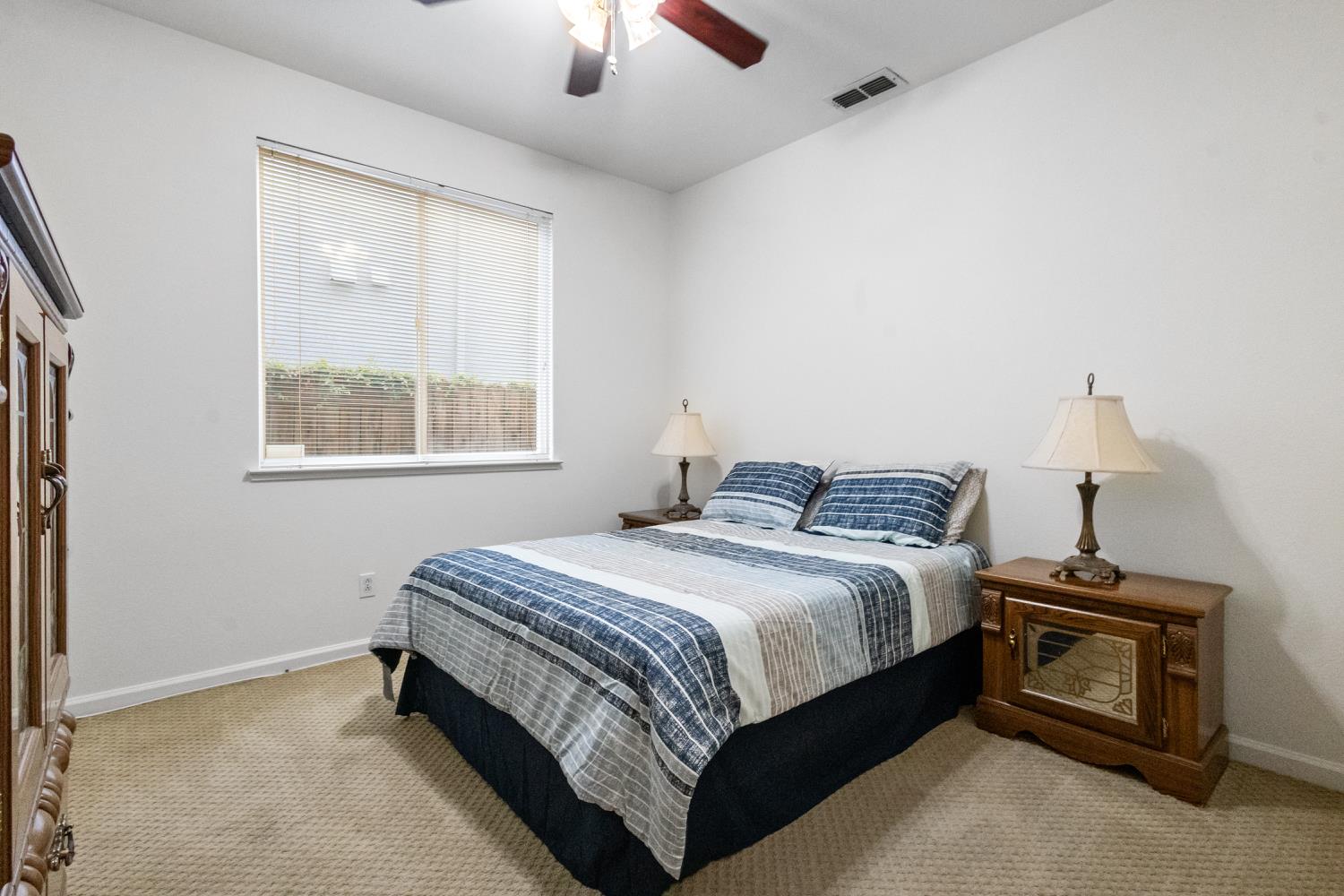 1413 Villette Court Modesto, CA 95356 - Photo 33 of 82 a bedroom with a bed and a chandelier