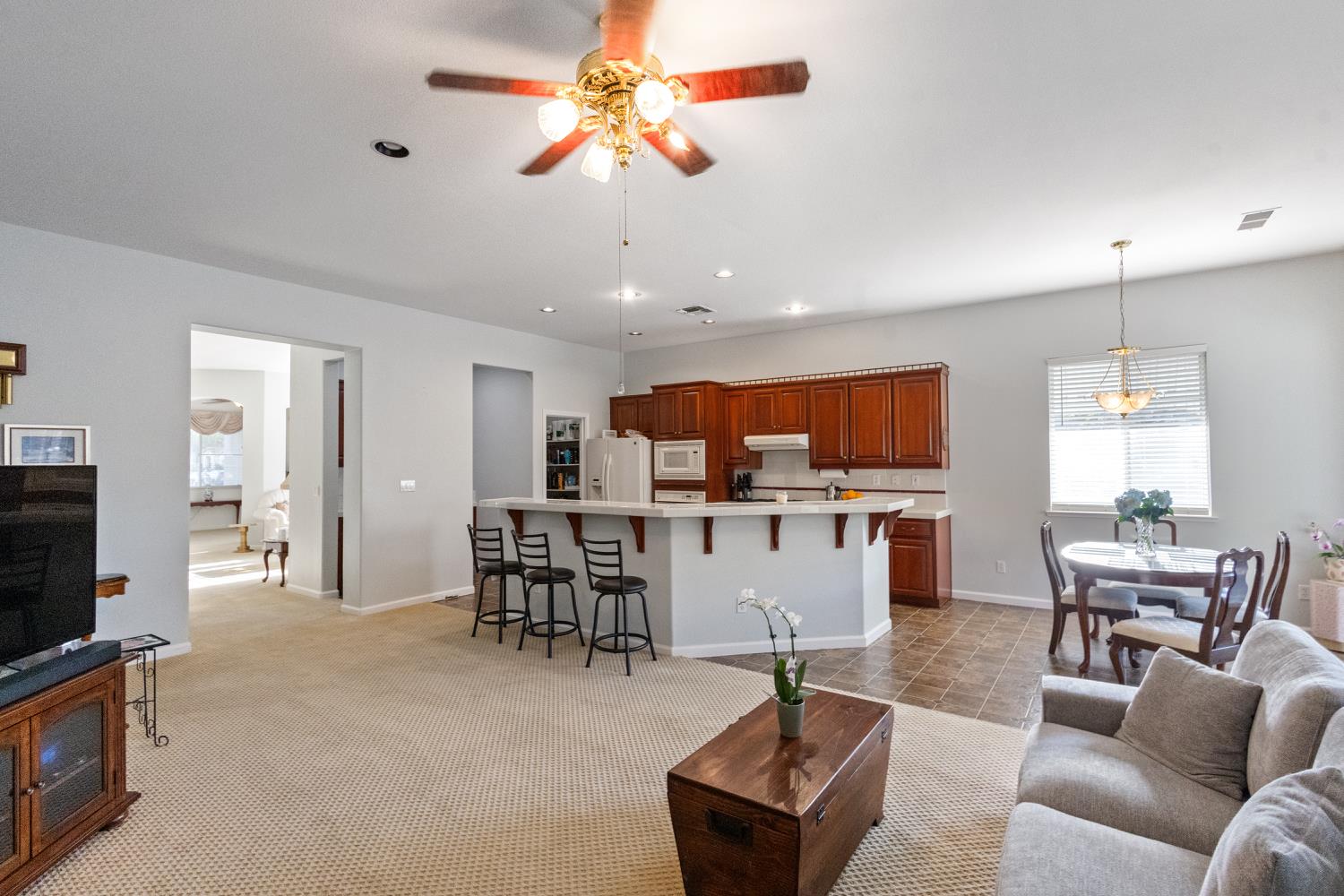 1413 Villette Court Modesto, CA 95356 - Photo 36 of 82 a living room with furniture kitchen view and a flat screen tv