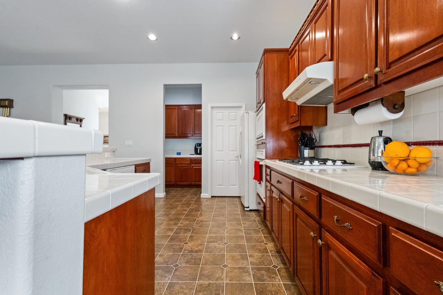 1413 Villette Court Modesto, CA 95356 - Photo 46 of 82 a kitchen with stainless steel appliances granite countertop a sink a stove and a refrigerator