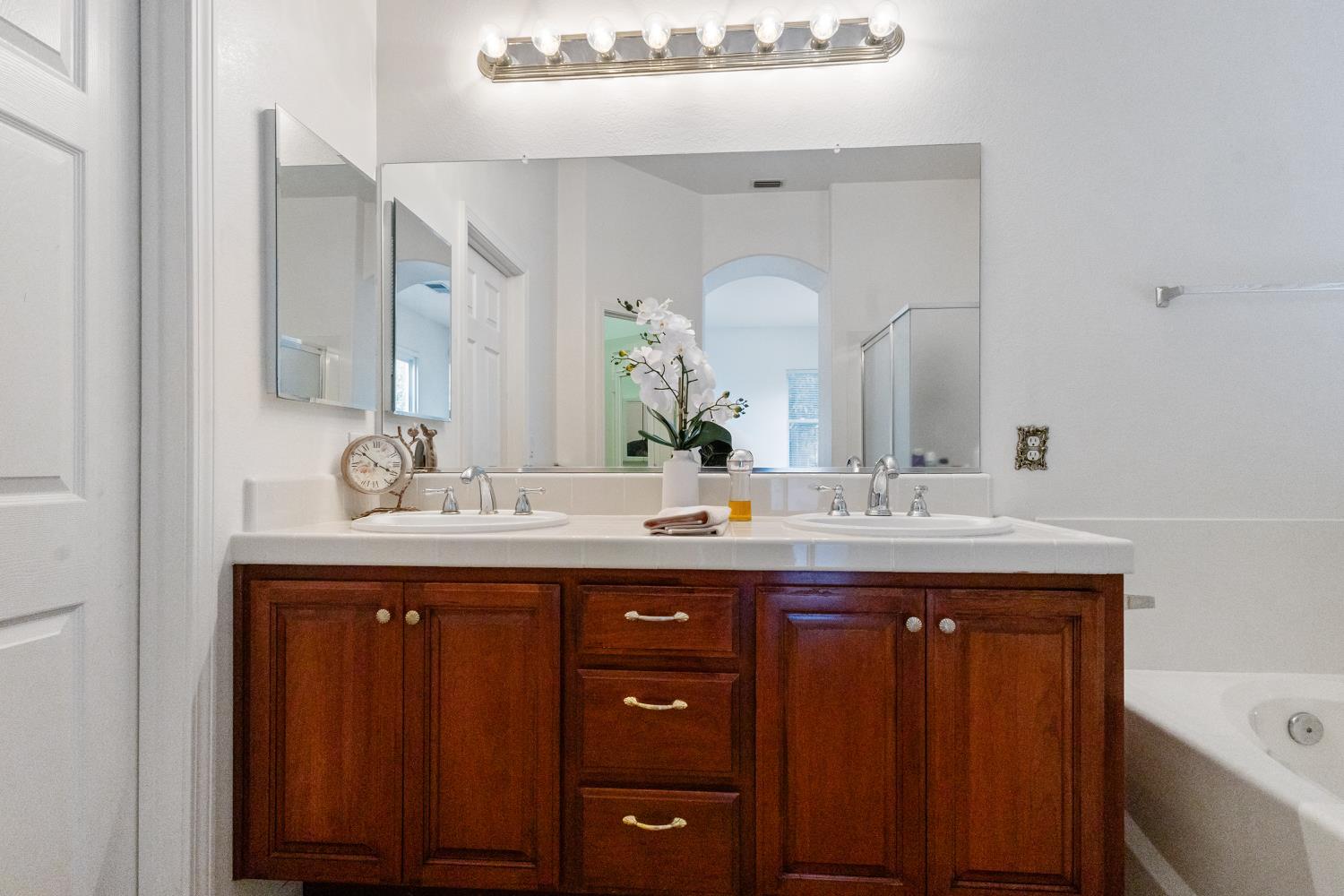 1413 Villette Court Modesto, CA 95356 - Photo 51 of 82 a bathroom with a double vanity sink and a mirror