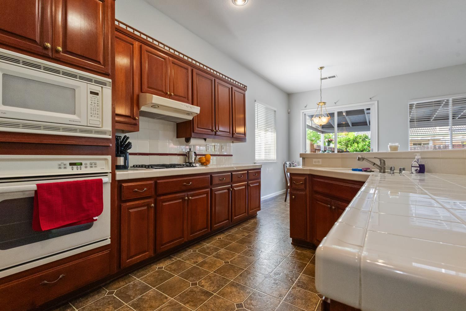 1413 Villette Court Modesto, CA 95356 - Photo 81 of 82 a kitchen with stainless steel appliances granite countertop a stove a sink and a microwave