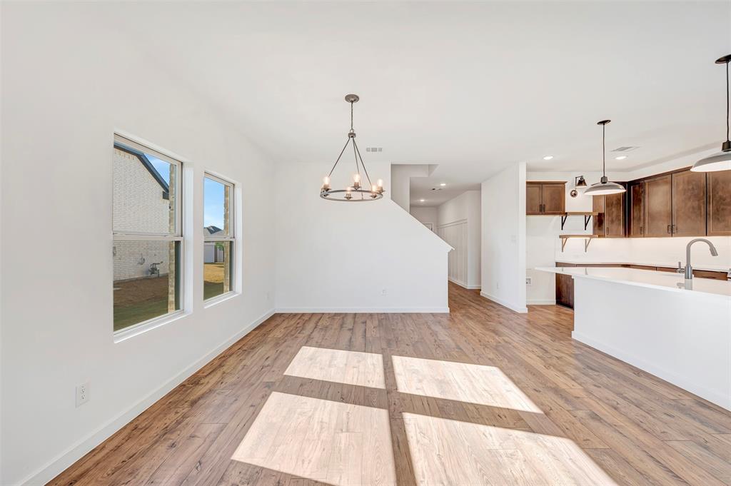 2217 Maple Ridge Drive Van Alstyne, TX 75495 - Photo 11 of 38 a view of a kitchen with a sink and dishwasher with wooden floor