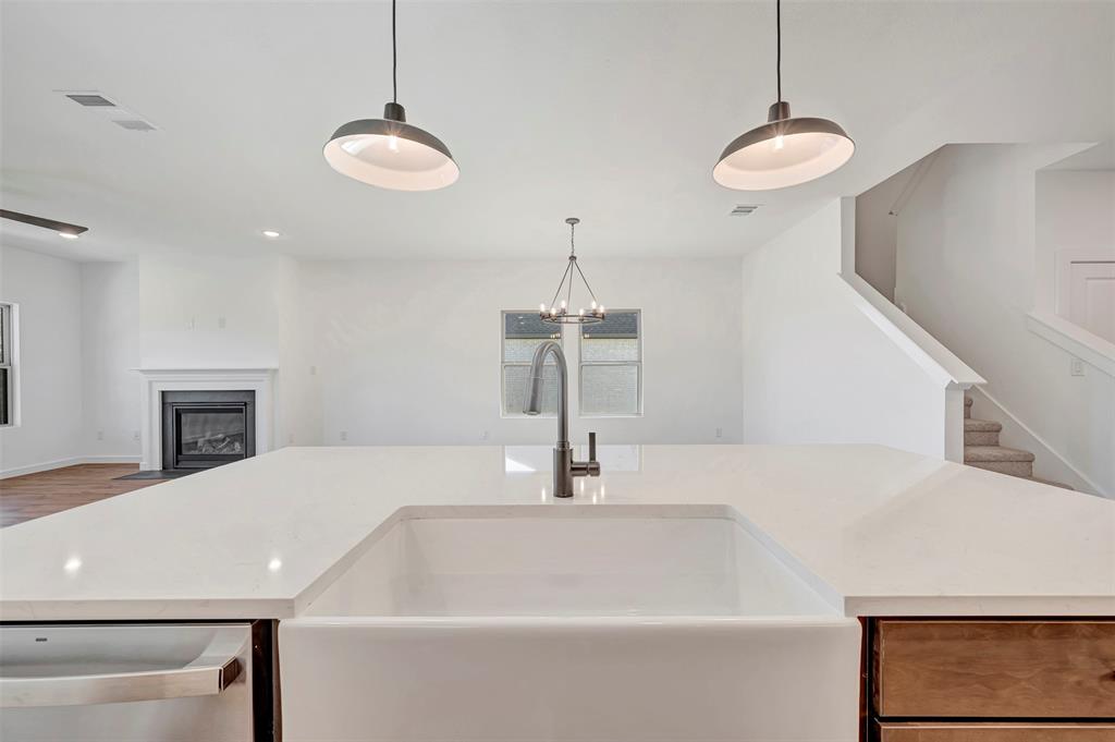 2217 Maple Ridge Drive Van Alstyne, TX 75495 - Photo 19 of 38 a kitchen with a sink and chandelier