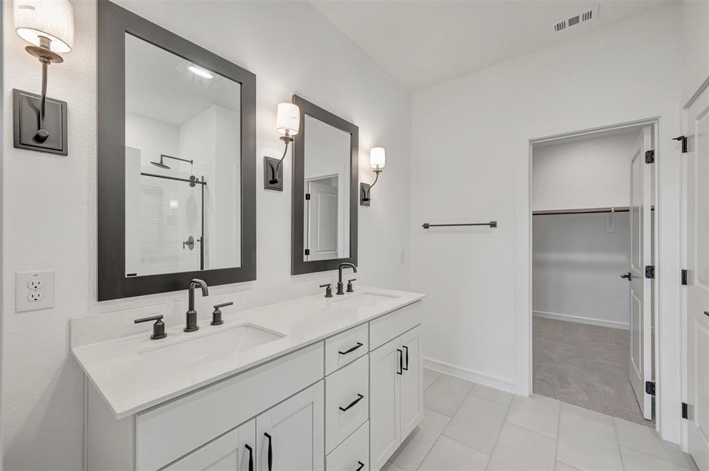 2217 Maple Ridge Drive Van Alstyne, TX 75495 - Photo 22 of 38 a bathroom with a double vanity sink mirror and double