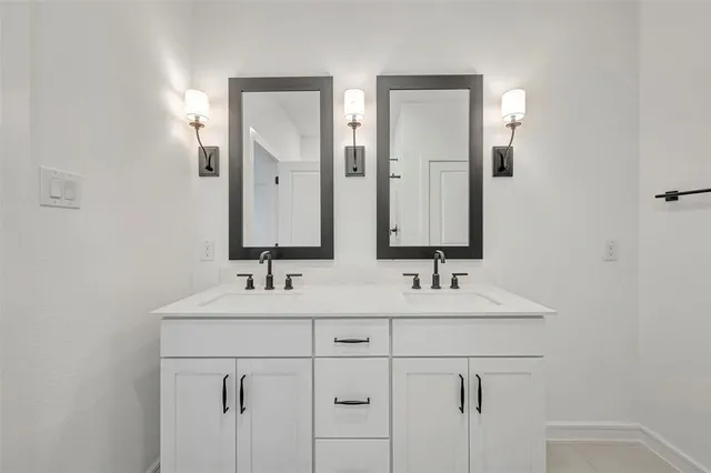 a bathroom with a double vanity sink mirror and double