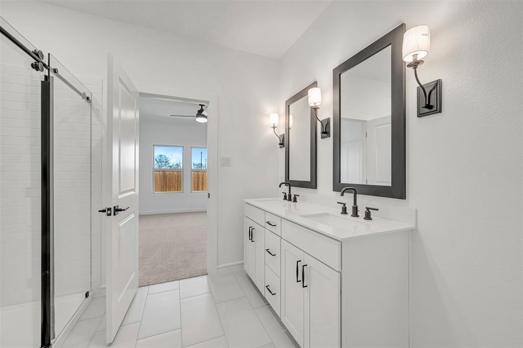 2217 Maple Ridge Drive Van Alstyne, TX 75495 - Photo 24 of 38 a bathroom with a double vanity sink mirror and double