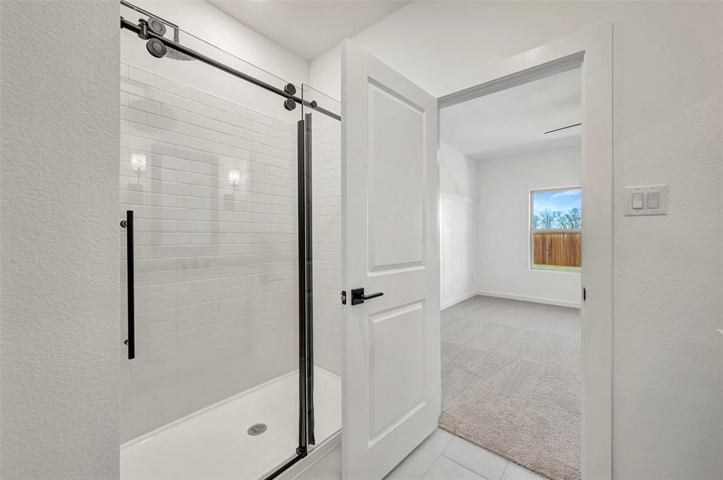 2217 Maple Ridge Drive Van Alstyne, TX 75495 - Photo 25 of 38 a bathroom with a shower and a sink