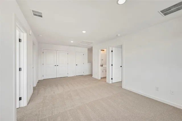 a view of a big room with closet and windows