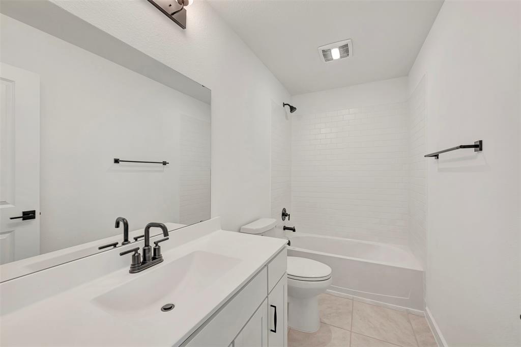 2217 Maple Ridge Drive Van Alstyne, TX 75495 - Photo 34 of 38 a bathroom with a sink toilet and shower