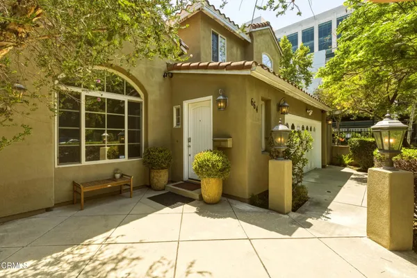 a front view of a house with outdoor seating