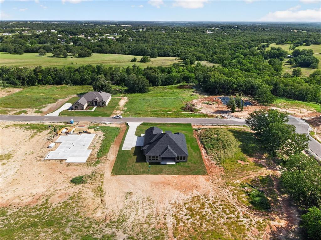416 McAlpine Drive Springtown, TX 76082 - Photo 39 of 40 New construction home featuring a dark shingle roof and light-colored exterior