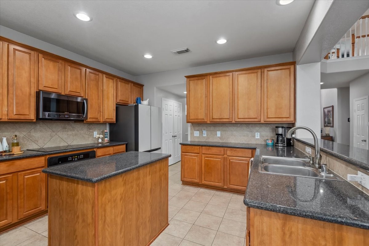 19222 Holly Shade Court Spring, TX 77379 - Photo 16 of 37 The pantry and utility room are between the kitchen and dining area for easy access and storage.