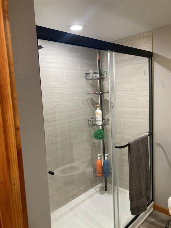 248 Shaffer Road Denison, TX 75021 - Photo 12 of 40 a bathroom with a glass shower door