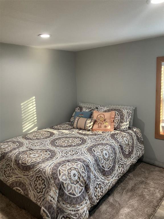 248 Shaffer Road Denison, TX 75021 - Photo 15 of 40 a bed sitting in a bedroom next to a window