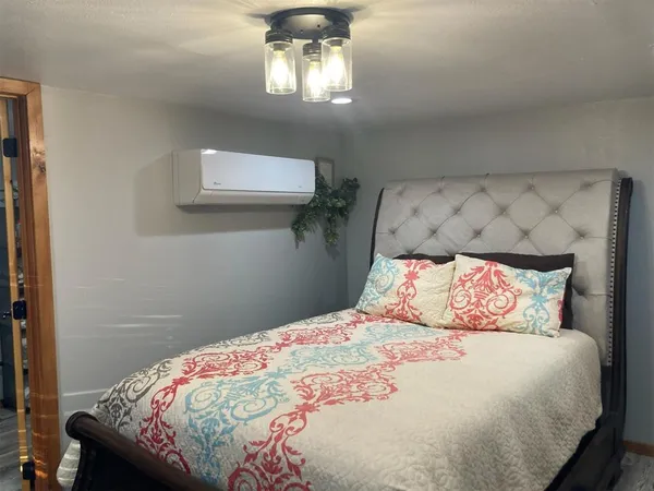 a bedroom with a bed and a chandelier