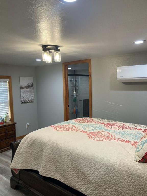 248 Shaffer Road Denison, TX 75021 - Photo 10 of 40 a bedroom with a bed and painting on the wall