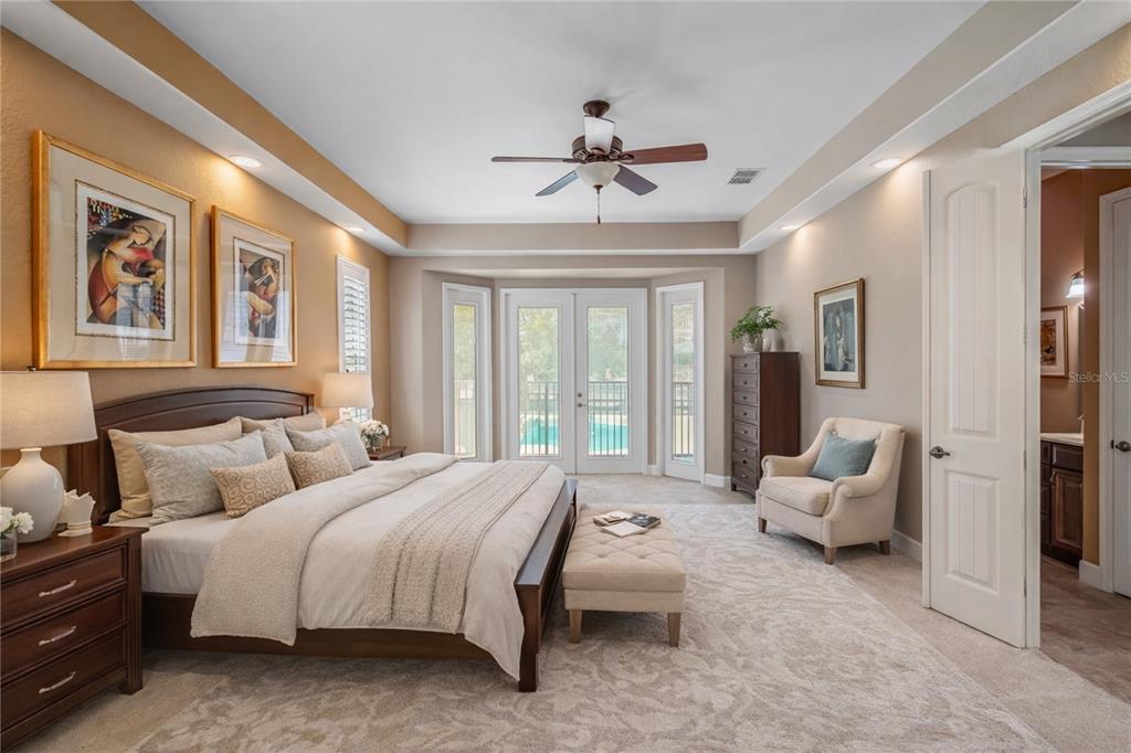 12610 Northwest Gainesville Road Reddick, FL 32686 - Photo 22 of 90 a spacious bedroom with a bed and glass walk in closet
