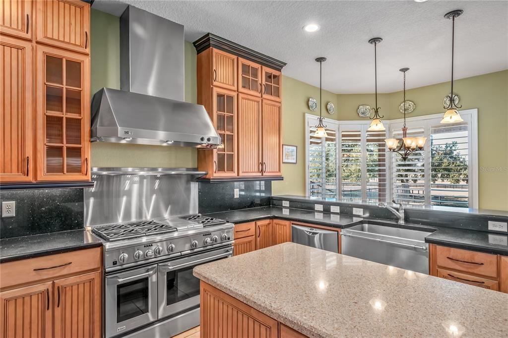 12610 Northwest Gainesville Road Reddick, FL 32686 - Photo 32 of 90 a kitchen with a stove a sink and a refrigerator
