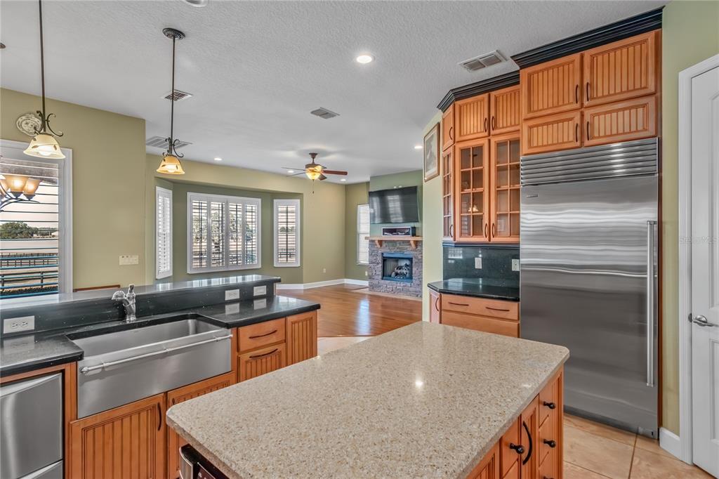 12610 Northwest Gainesville Road Reddick, FL 32686 - Photo 33 of 90 a kitchen with granite countertop a sink and a refrigerator
