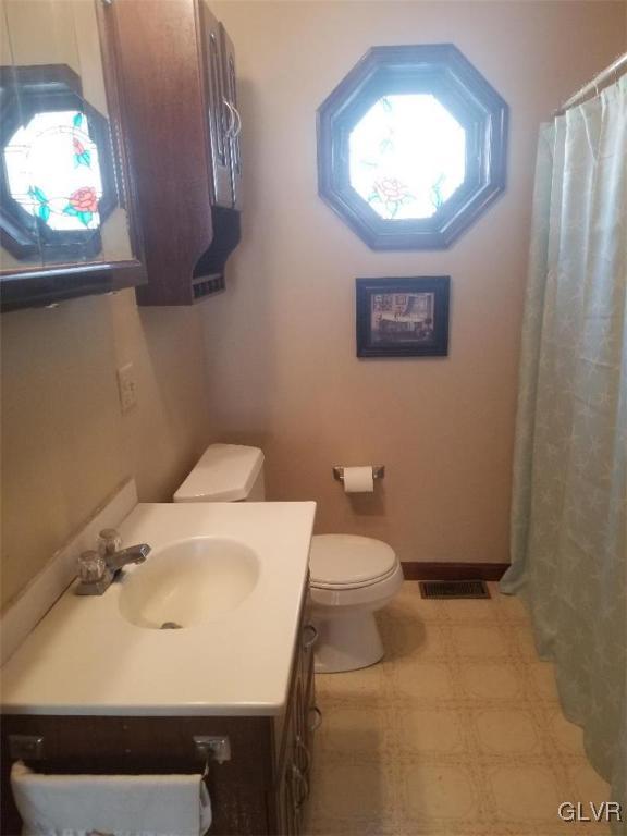 2227 Main Street Northampton, PA 18067 - Photo 20 of 31 a bathroom with a sink a mirror and a toilet