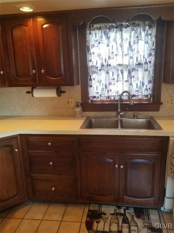 2227 Main Street Northampton, PA 18067 - Photo 5 of 31 a sink with wooden cabinets and a window