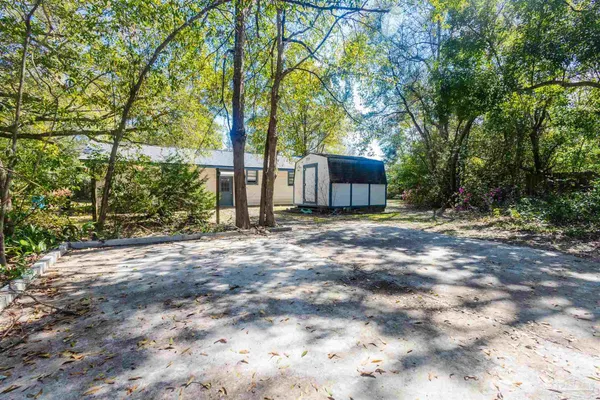 a view of a house with yard and tree s