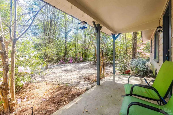 a view of a porch with chairs and table in the patio