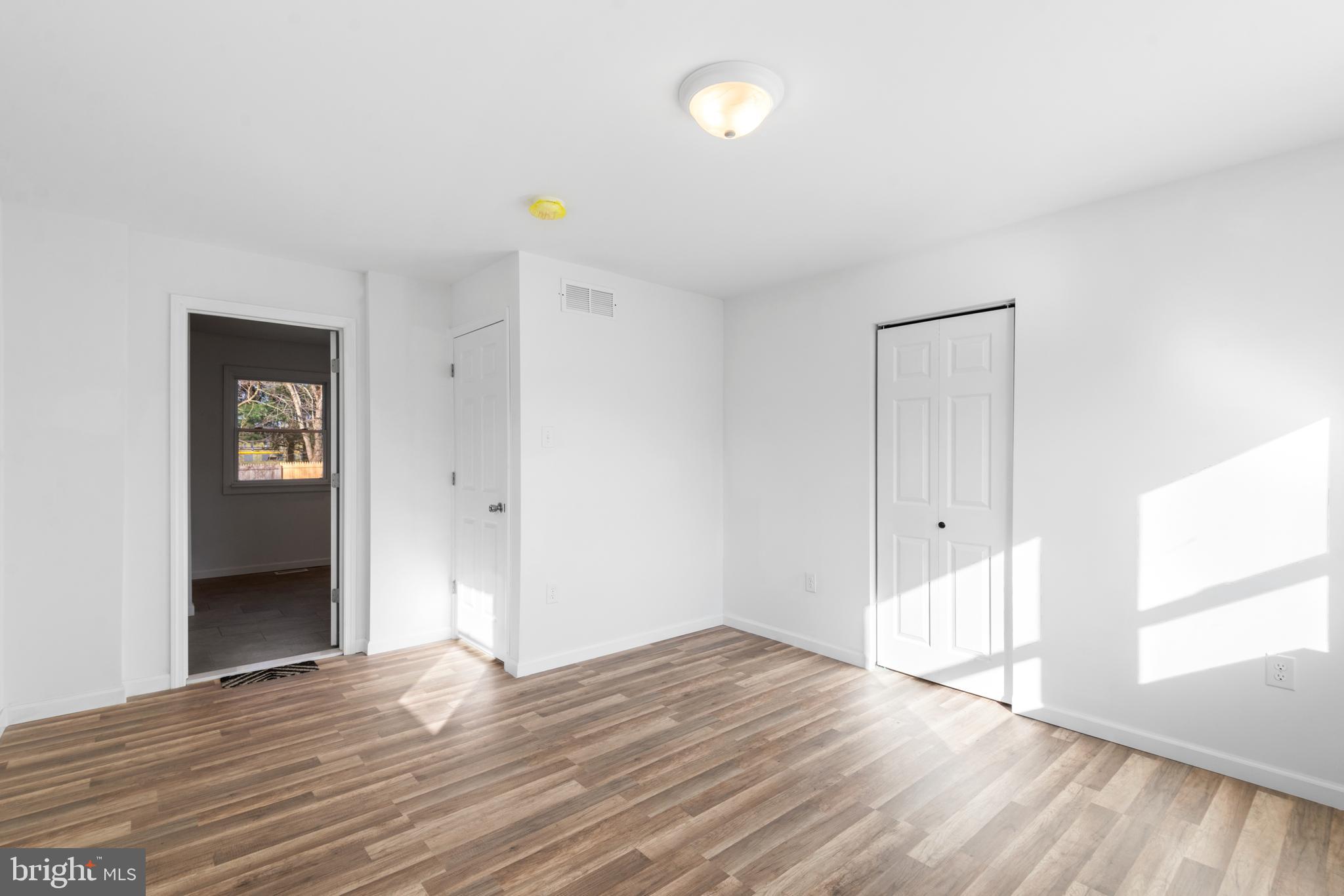 129 Marlton Road Pilesgrove, NJ 08098 - Photo 12 of 27 a view of empty room with wooden floor and fan