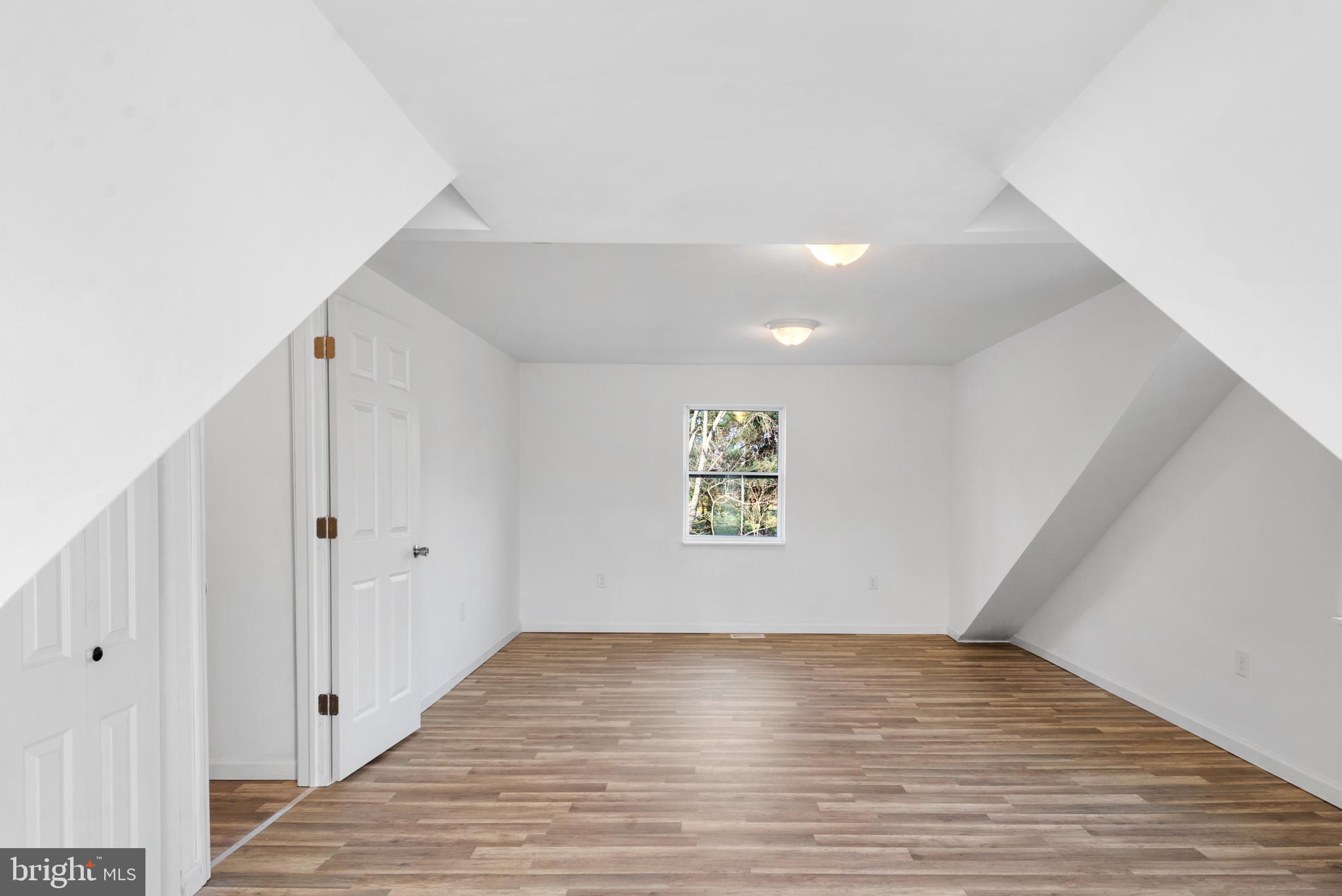 129 Marlton Road Pilesgrove, NJ 08098 - Photo 17 of 27 a view of an empty room with wooden floor and a window