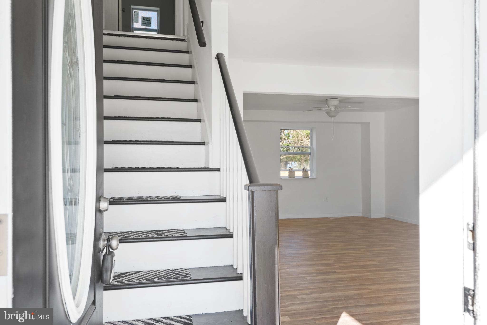 129 Marlton Road Pilesgrove, NJ 08098 - Photo 3 of 27 a view of staircase with white walls and a window
