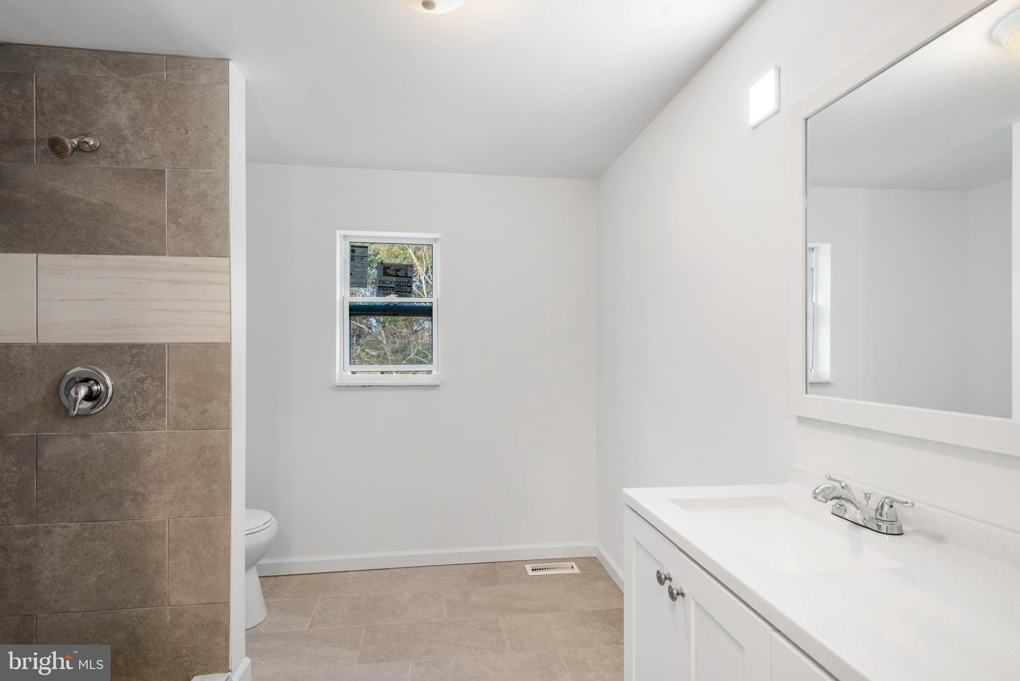 129 Marlton Road Pilesgrove, NJ 08098 - Photo 21 of 27 a bathroom with a sink a vanity and shower